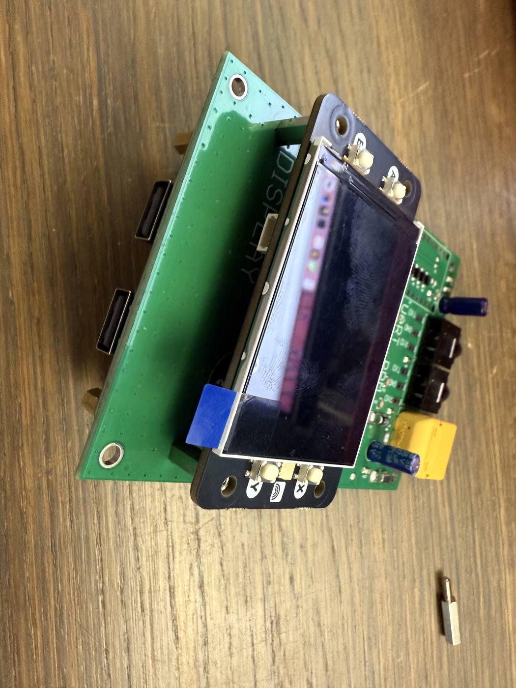 The screen seated on the mainboard, its A, B, X and Y buttons facing out