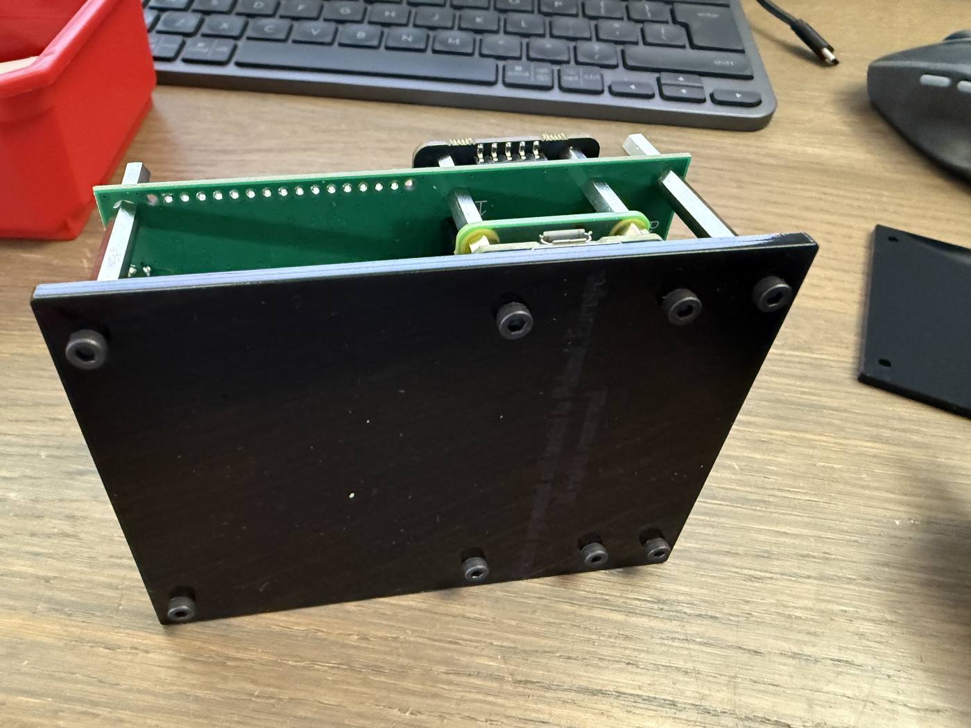 The base plate bolted on from below, closing the bottom of the enclosure