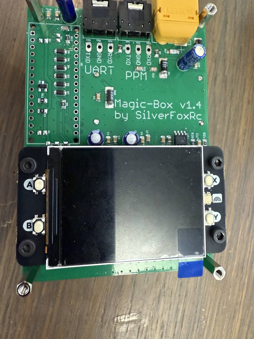 The screen screwed down to the mainboard, one screw at each of its four corners