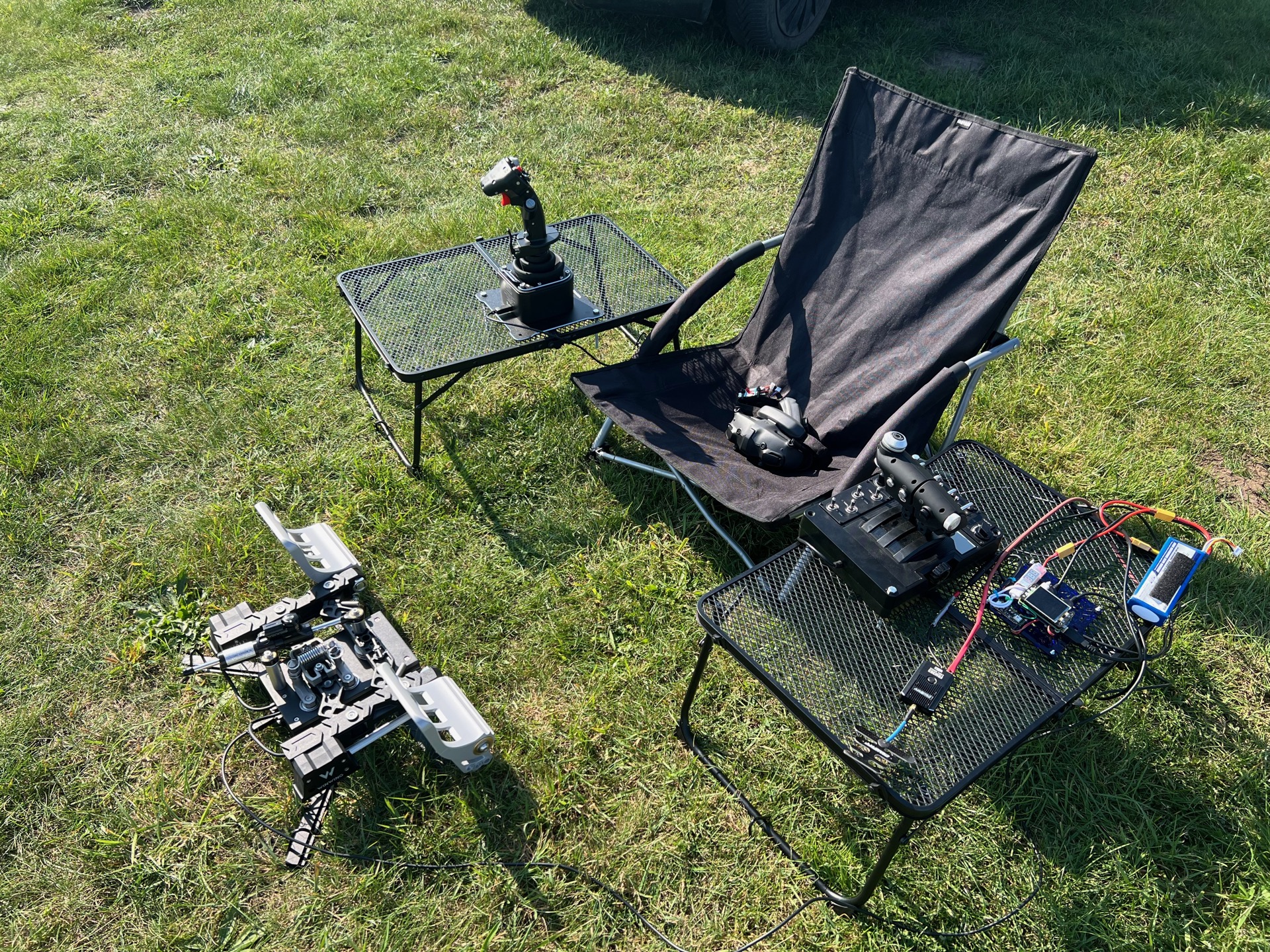 Magic Box rig — battery, controller, throttle, radio module, FPV goggles, joystick, pedals